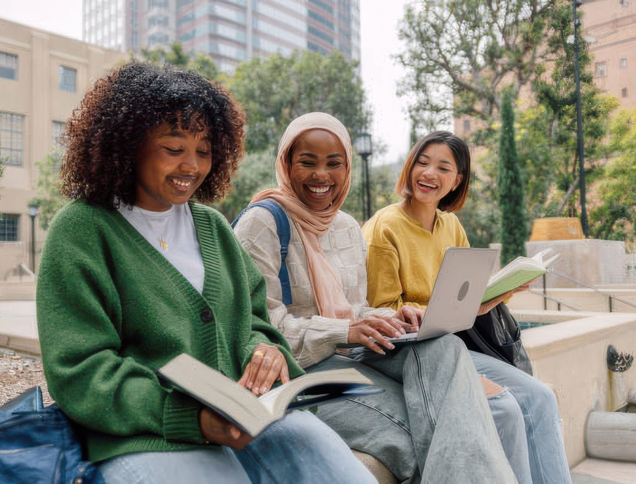 Three teenage student friends studying outdoors in the University campus. Three teenage student friends studying outdoors in the University campus.